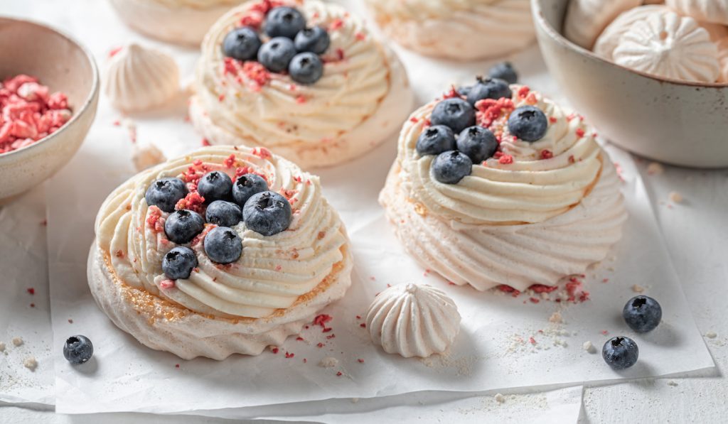 homemade small pavlova cakes with blueberries on top